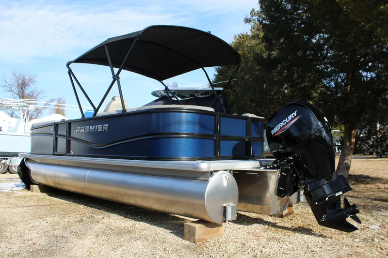 The Image of 2026 Premier 220 Sunscape RF pontoon boat with Mercury outboard motor, parked on land. - 0