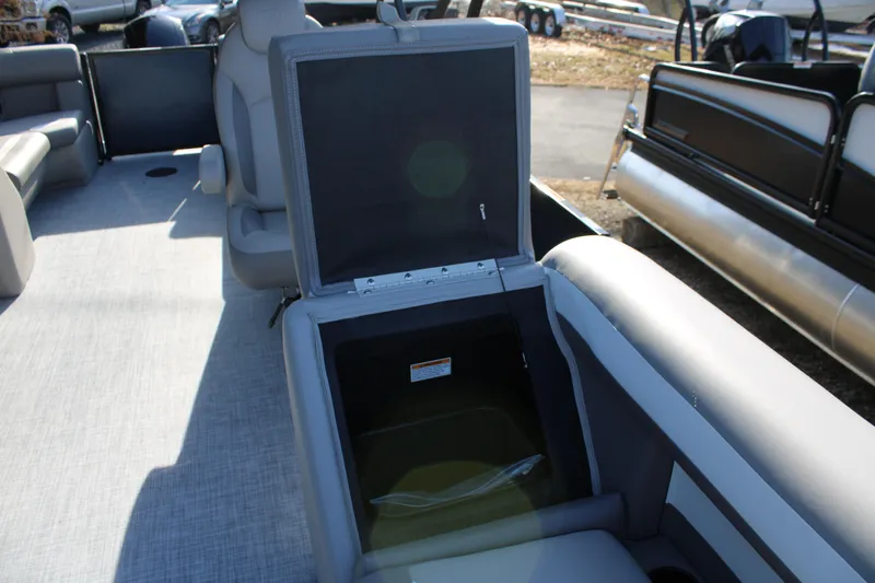 Slide: The Image of 2026 Premier 220 Sunscape RF boat interior with open storage compartment. - 11