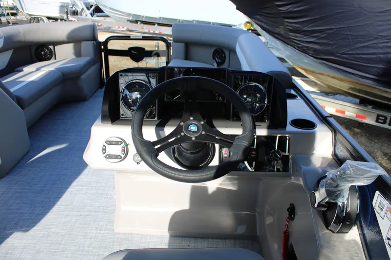 Slide: The Image of 2026 Premier 220 Sunscape RF boat interior with steering wheel and dashboard controls. - 8