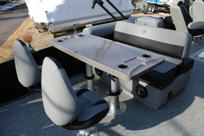 Slide: The Image of 2026 Premier 230 Sunsation RS boat interior with seating and table, featuring cup holders. - 6