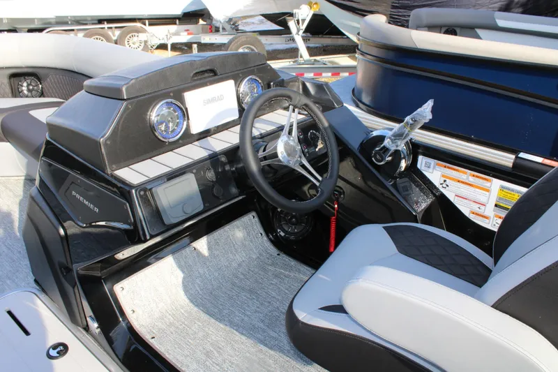 Slide: The Image of 2026 Premier 230 Sunsation RS boat dashboard with steering wheel and control panel. - 9