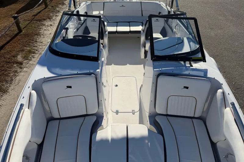 Slide: The Image of 2026 Stingray 231 DC boat interior with white seating and open windshield. - 10