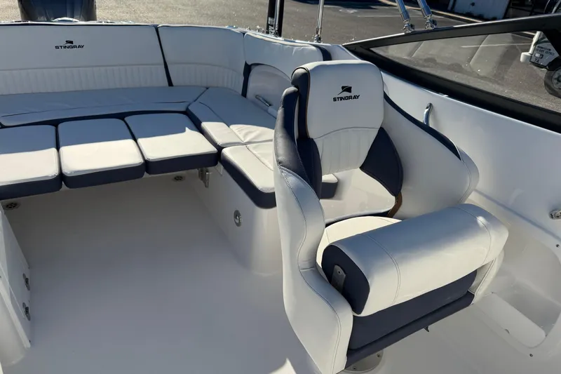 Slide: The Image of 2026 Stingray 231 DC boat interior with white and navy seating. - 13