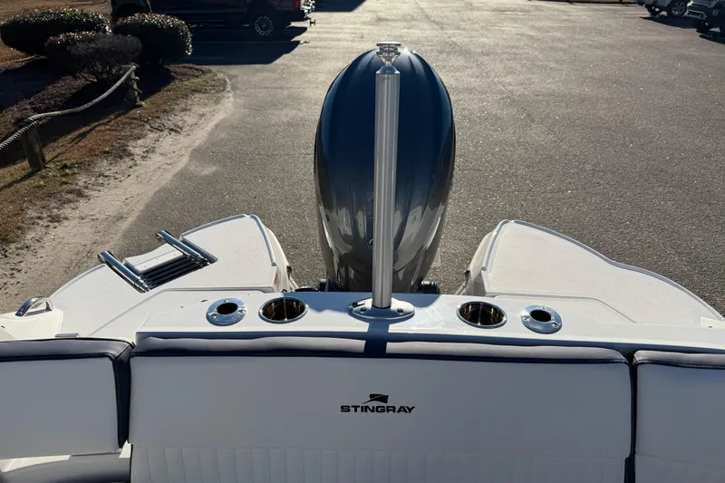 Slide: The Image of 2026 Stingray 231 DC boat rear view with motor and seating area. - 18