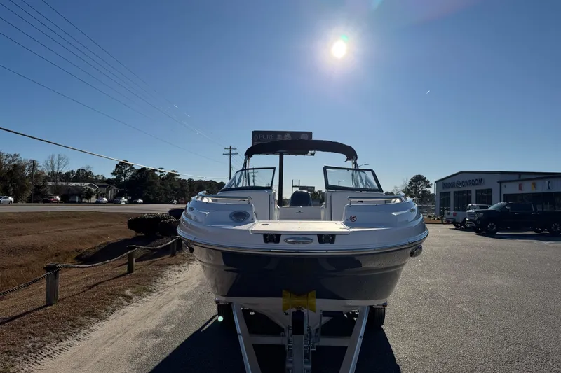 Slide: The Image of 2026 Stingray 231 DC boat on trailer under clear blue sky. - 7