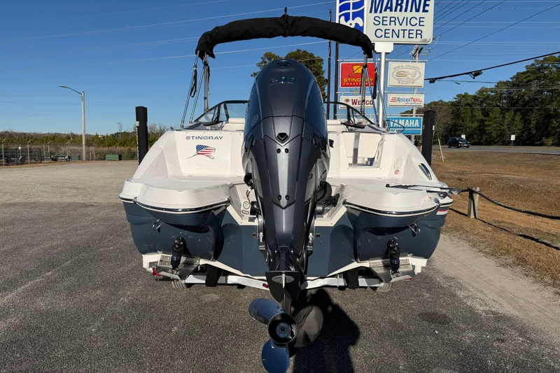 Slide: The Image of 2026 Stingray 231 DC boat with outboard motor at marine service center. - 8