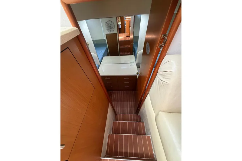 Slide: The Image of Interior of 2001 Ocean Yachts 40 Super Sport, featuring wooden stairs and cabinetry. - 16