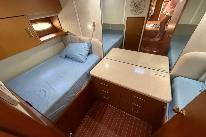 Slide: The Image of Interior cabin of 2001 Ocean Yachts 40 Super Sport with twin beds and wooden cabinetry. - 17