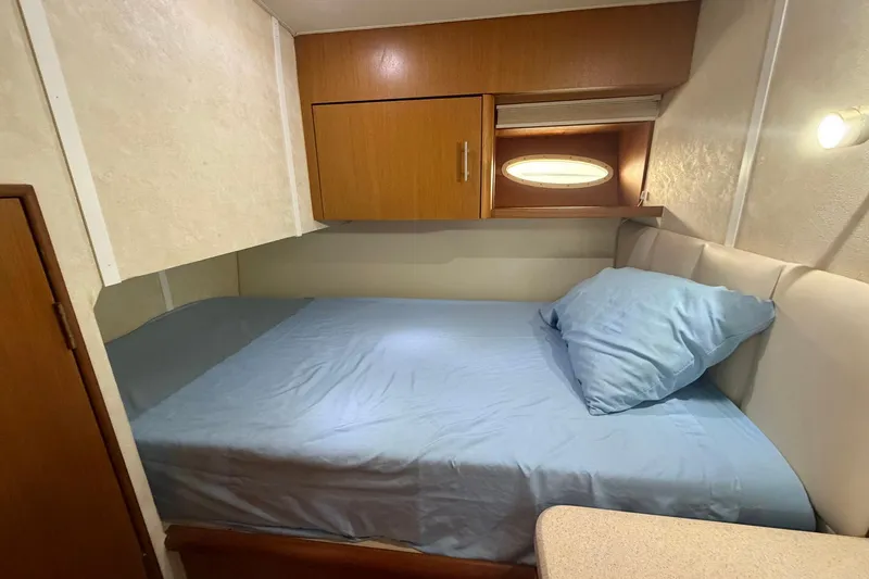 Slide: The Image of Cozy cabin interior of 2001 Ocean Yachts 40 Super Sport with bed and wooden cabinetry. - 18