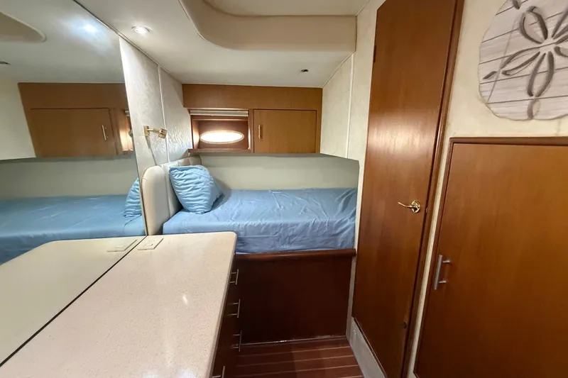 Slide: The Image of Interior cabin of 2001 Ocean Yachts 40 Super Sport with bed and wooden cabinetry. - 19