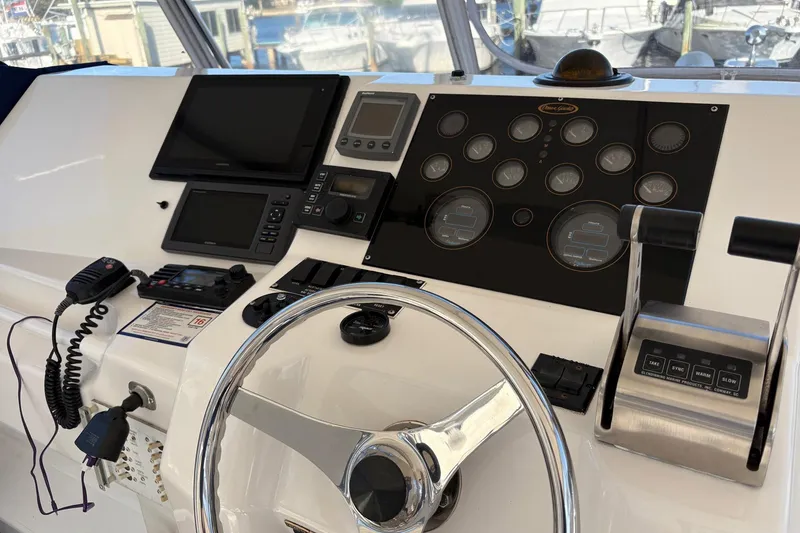 Slide: The Image of Control panel of a 2001 Ocean Yachts 40 Super Sport with steering wheel and navigation instruments. - 2