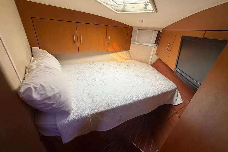Slide: The Image of Cozy cabin interior of 2001 Ocean Yachts 40 Super Sport with bed and storage cabinets. - 21
