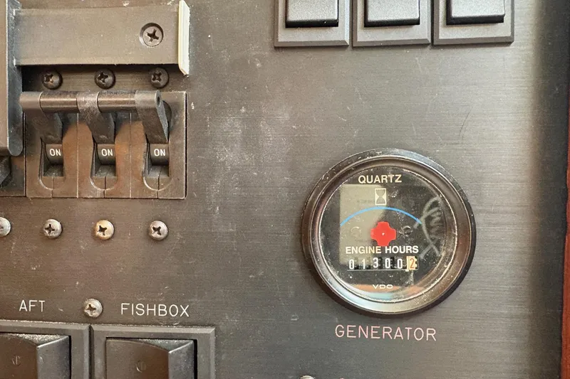 Slide: The Image of Control panel of a 2001 Ocean Yachts 40 Super Sport, showing engine hours and switches. - 5