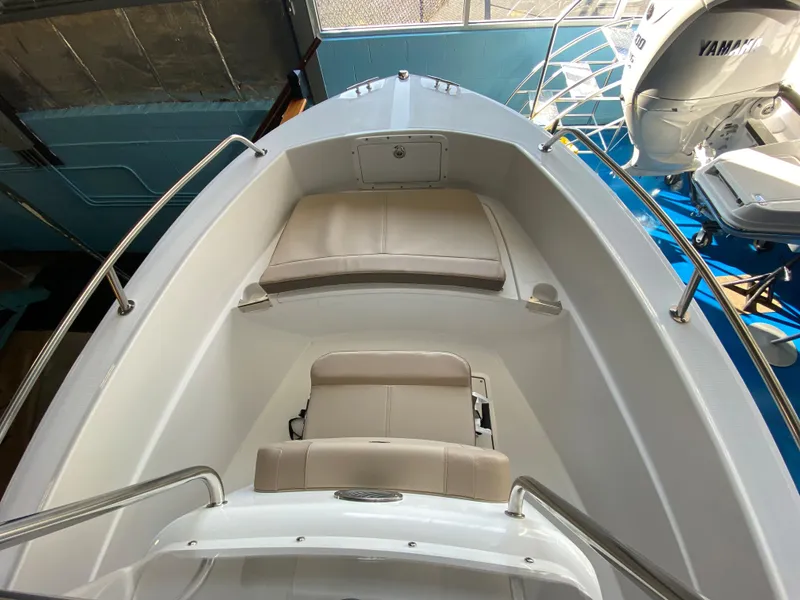 Slide: The Image of 2024 Edgewater 170CC Center Console boat interior with seating and Yamaha engine. - 4