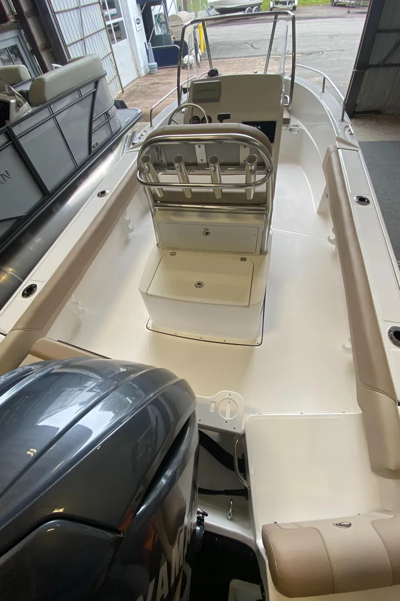 Slide: The Image of 2024 Edgewater 188CC Center Console boat interior with seating and outboard motor. - 2