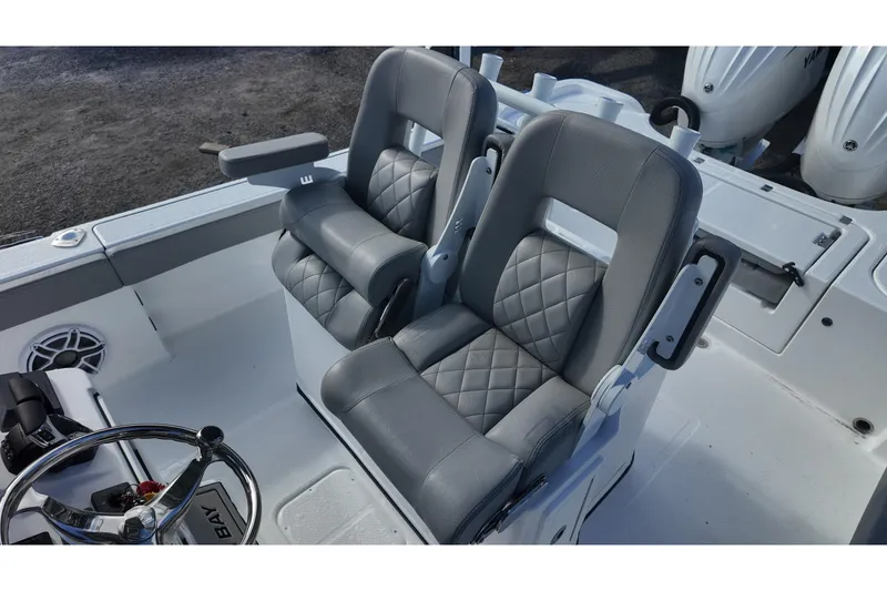 Slide: The Image of 2026 Blazer Bay Makaira 2800 boat seats with quilted gray upholstery and armrests. - 18
