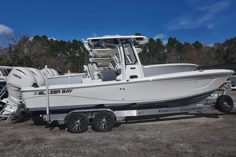 Slide: The Image of 2026 Blazer Bay Makaira 2800 boat on trailer with Yamaha engines, side view. - 3