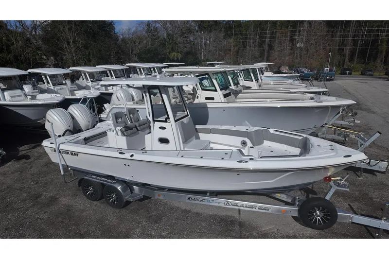 Slide: The Image of 2026 Blazer Bay Makaira 2800 boats lined up on trailers in a dealership lot. - 4