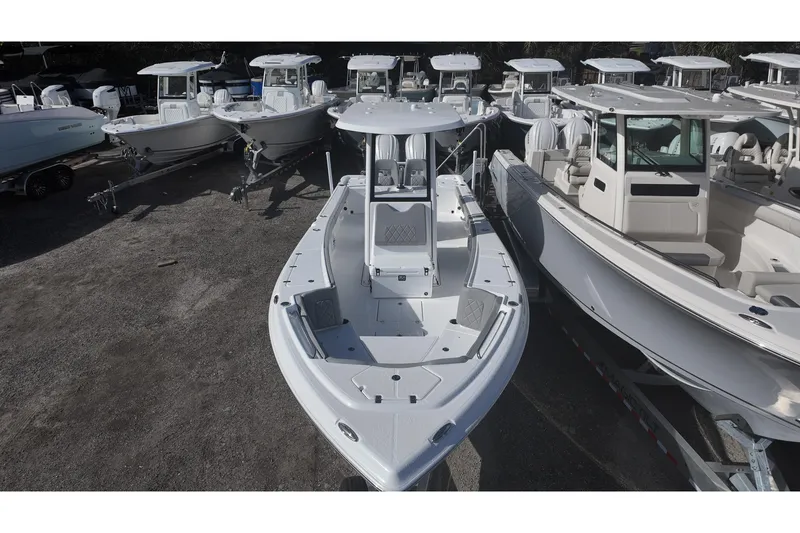 Slide: The Image of 2026 Blazer Bay Makaira 2800 boat displayed among other vessels in a showroom. - 6