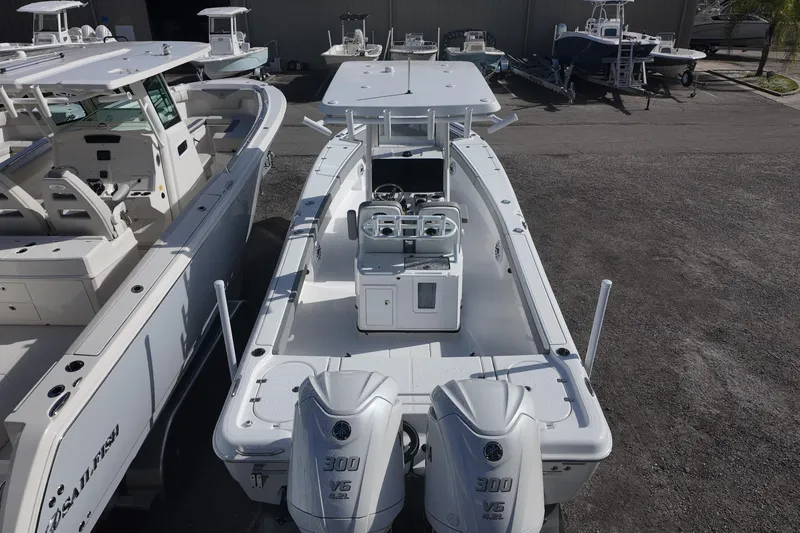 Slide: The Image of 2026 Blazer Bay Makaira 2800 boat with dual engines, docked in a marina. - 7