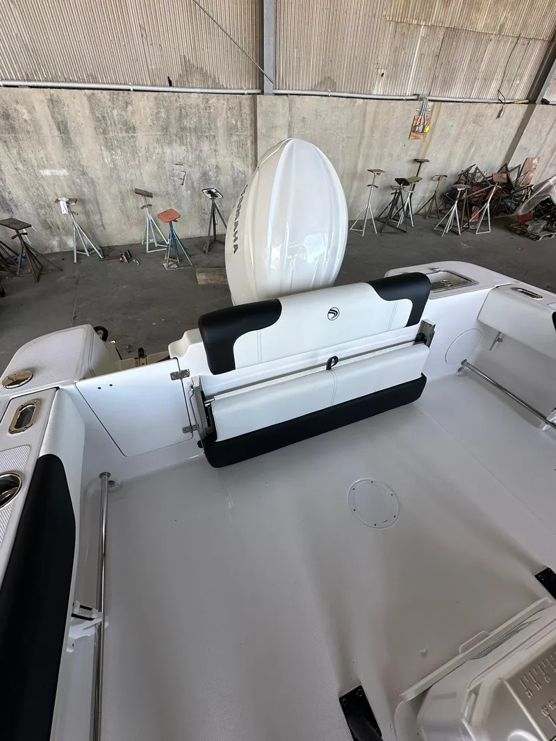 Slide: The Image of 2025 Edgewater 208CC Center Console boat interior with seating and engine view. - 10