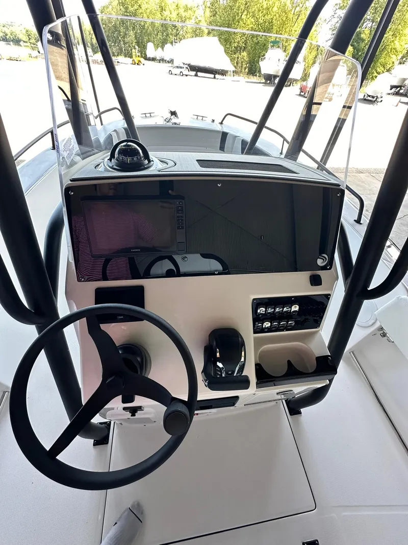 Slide: The Image of 2025 Edgewater 208CC Center Console boat dashboard with steering wheel and controls. - 14
