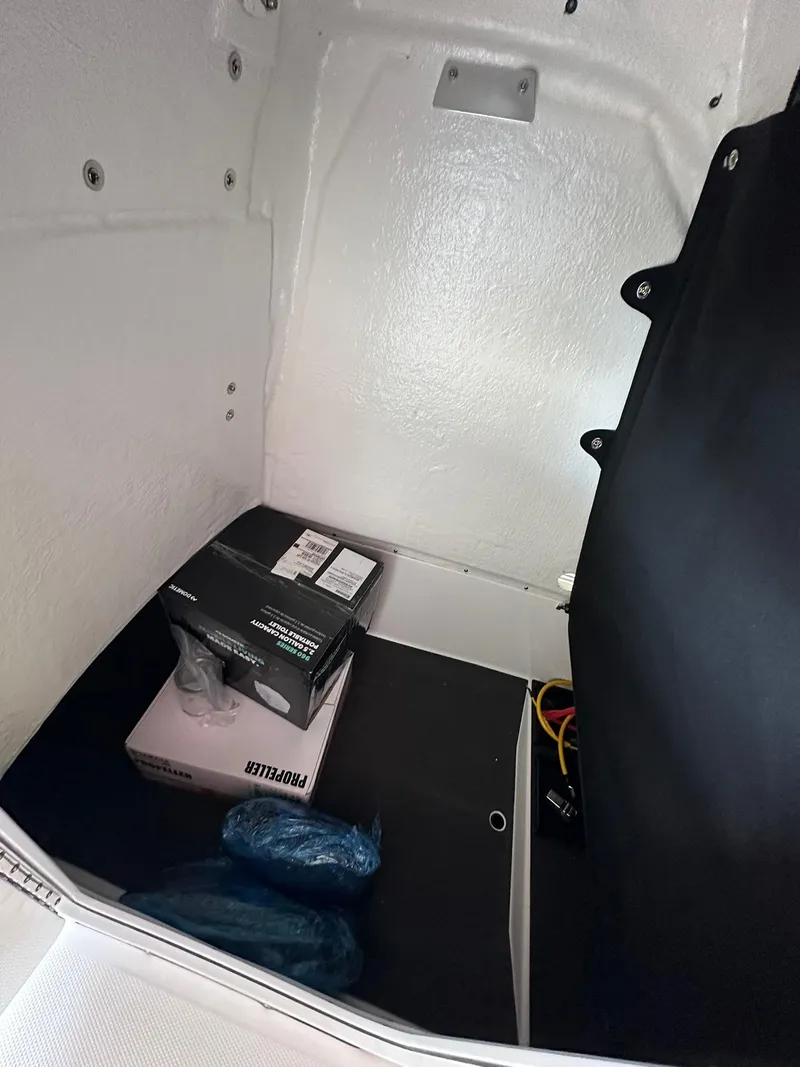 Slide: The Image of Interior storage of 2025 Edgewater 208CC Center Console boat with equipment boxes. - 17