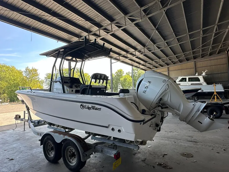 Slide: The Image of 2025 Edgewater 208CC Center Console boat on trailer in covered storage. - 4