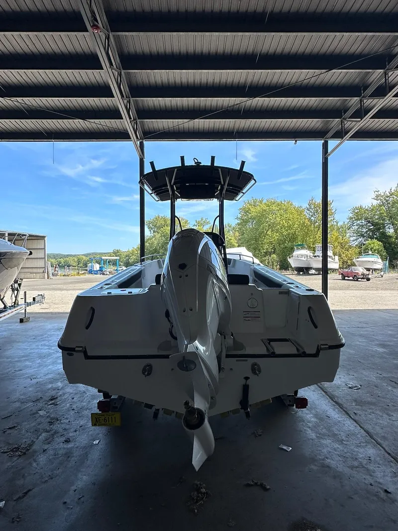 Slide: The Image of 2025 Edgewater 208CC Center Console boat in a covered storage area. - 5