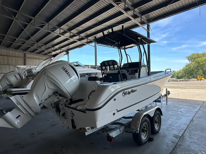 Slide: The Image of 2025 Edgewater 208CC Center Console boat with Yamaha engine in a covered storage area. - 6