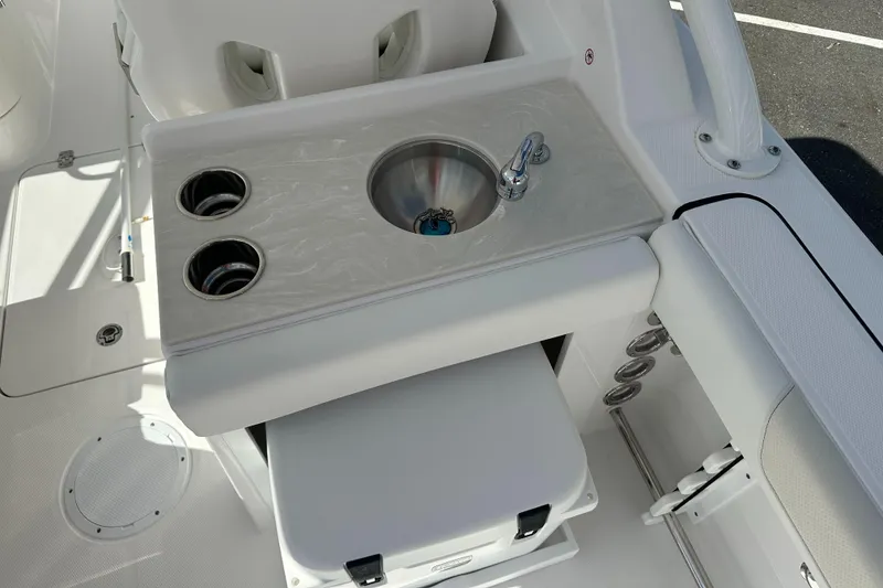 Slide: The Image of 2025 Edgewater 248CX Crossover boat interior with sink and cup holders. - 17