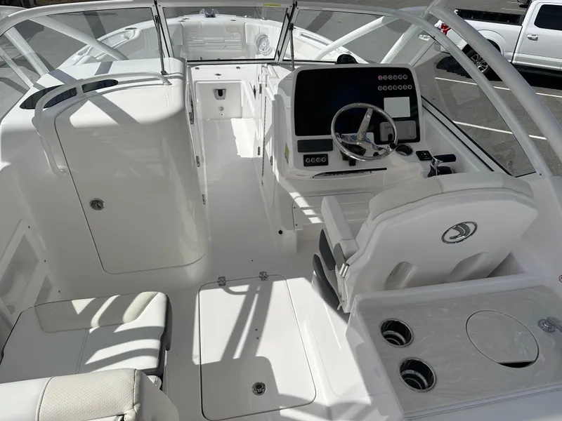 Slide: The Image of 2025 Edgewater 248CX Crossover boat interior with modern helm and seating. - 18