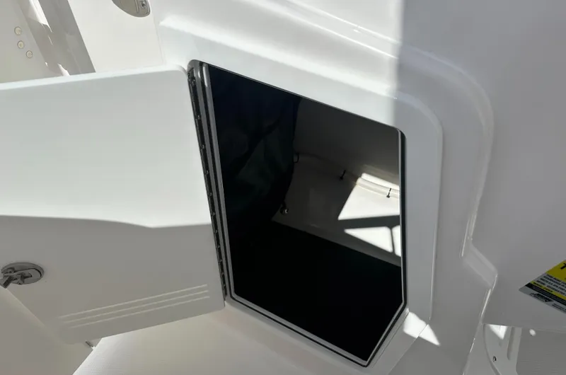 Slide: The Image of Open storage compartment on 2025 Edgewater 248CX Crossover boat. - 22