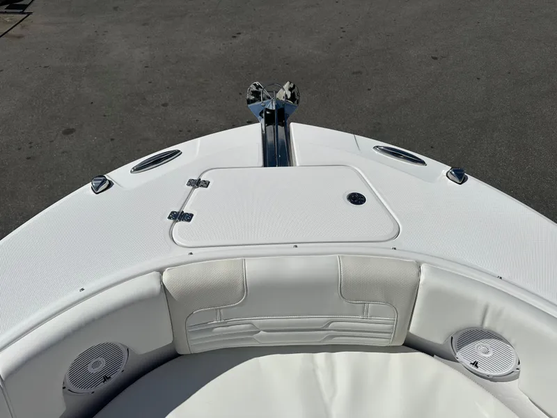 Slide: The Image of 2025 Edgewater 248CX Crossover boat bow with white seating and anchor. - 32