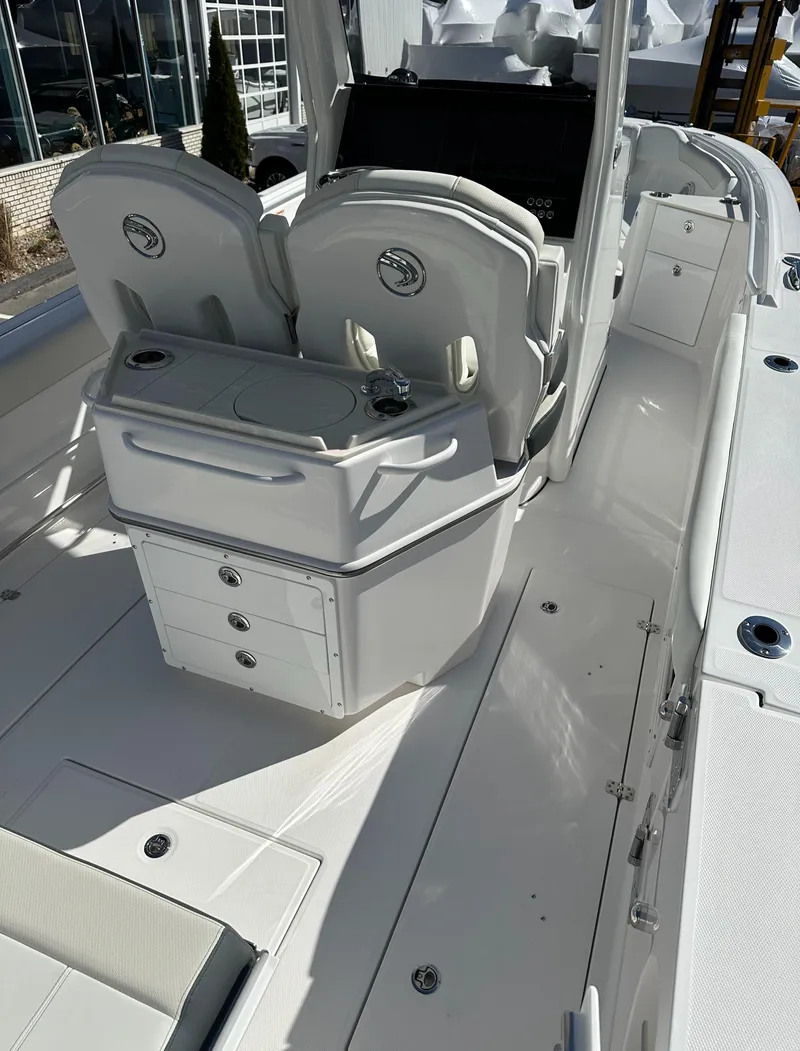 Slide: The Image of 2025 Edgewater 262 Center Console boat interior with seating and storage compartments. - 19