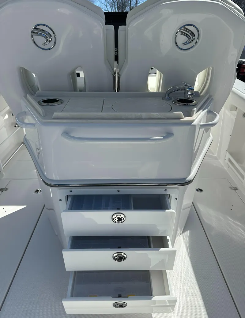 Slide: The Image of 2025 Edgewater 262 Center Console boat with open storage drawers and seating. - 20