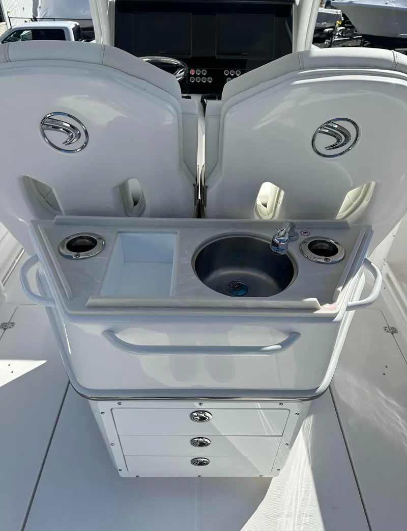 Slide: The Image of 2025 Edgewater 262 Center Console boat interior with sink and storage compartments. - 21