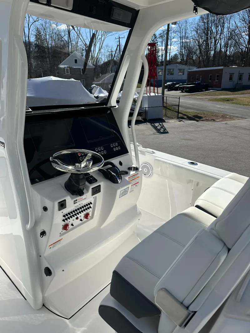 Slide: The Image of 2025 Edgewater 262 Center Console boat interior with modern dashboard and seating. - 22