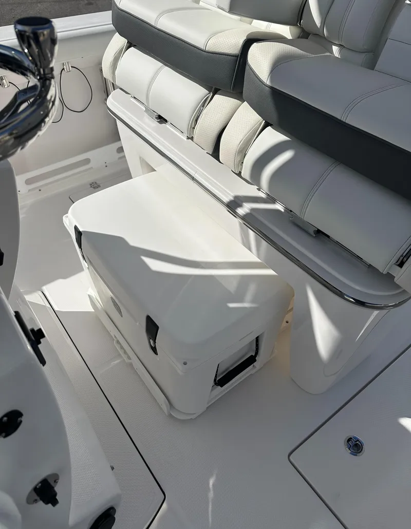 Slide: The Image of 2025 Edgewater 262 Center Console boat interior with cushioned seating and storage area. - 24