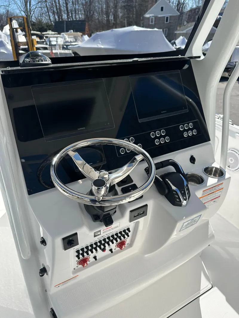 Slide: The Image of 2025 Edgewater 262 Center Console boat dashboard with steering wheel and control panel. - 25