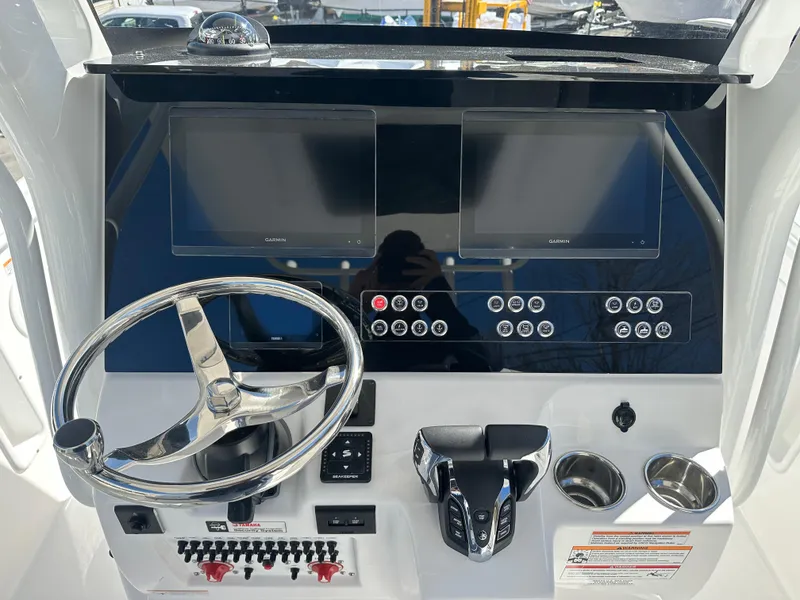 Slide: The Image of 2025 Edgewater 262 Center Console dashboard with dual screens and steering wheel. - 26