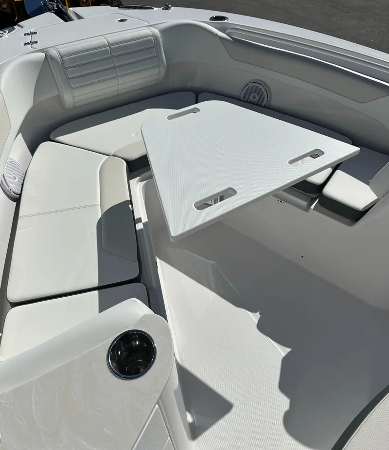 Slide: The Image of 2025 Edgewater 262 Center Console boat interior with white seating and table. - 33