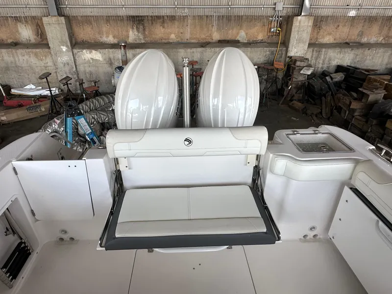 Slide: The Image of Edgewater 262CX Crossover 2026 boat interior with dual engines and seating area. - 10
