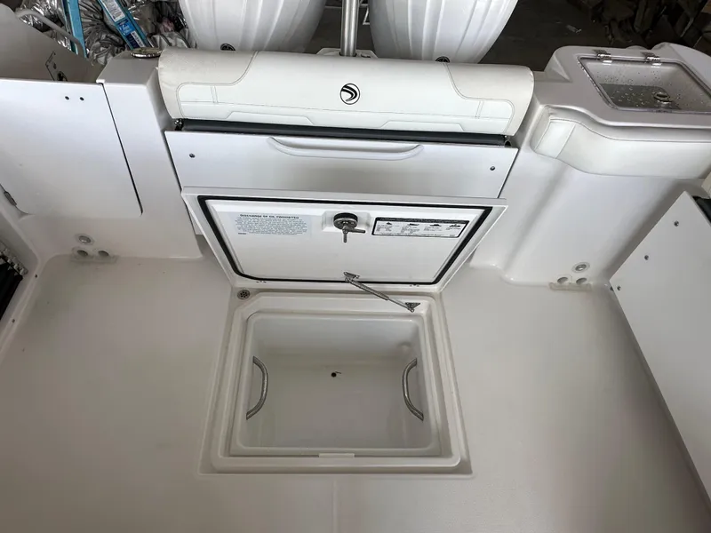 Slide: The Image of 2026 Edgewater 262CX Crossover boat interior with storage compartment and seating. - 11