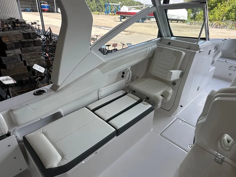Slide: The Image of 2026 Edgewater 262CX Crossover boat interior with white seating and modern design. - 17