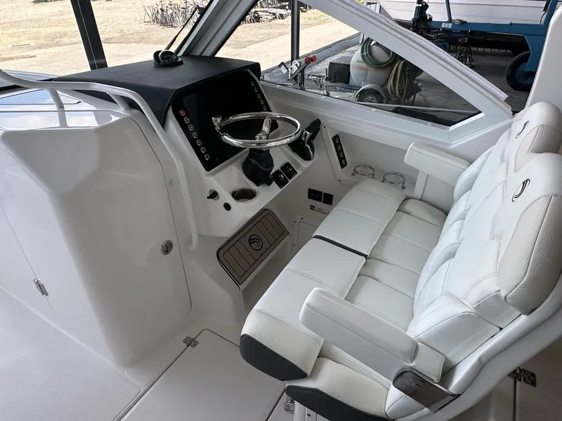 Slide: The Image of Interior of 2026 Edgewater 262CX Crossover boat with modern helm and seating. - 23