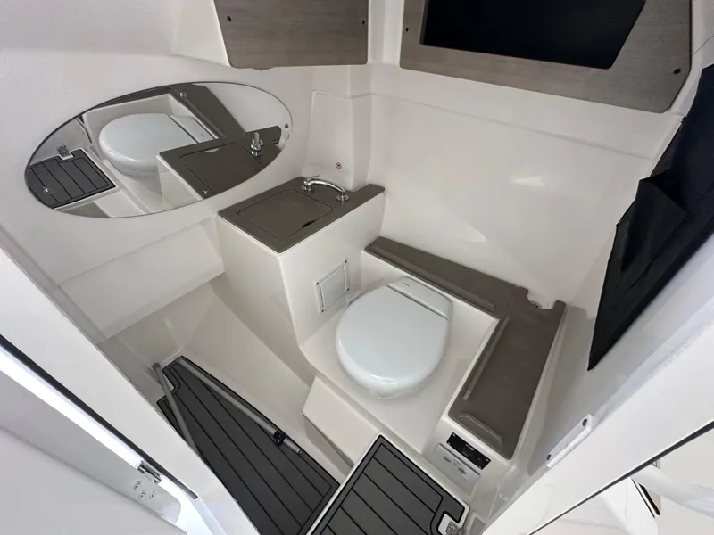 Slide: The Image of Interior of 2026 Edgewater 262CX Crossover boat bathroom with modern fixtures. - 27