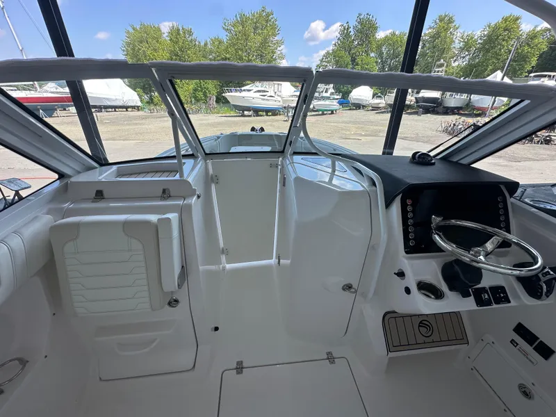 Slide: The Image of Interior view of 2026 Edgewater 262CX Crossover boat, featuring sleek design and modern controls. - 28