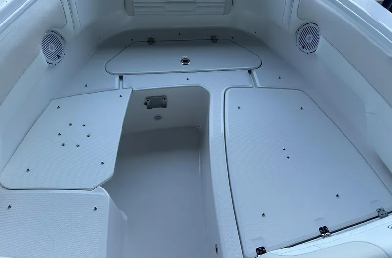 Slide: The Image of 2026 Edgewater 262CX Crossover boat interior with storage compartments and speakers. - 30