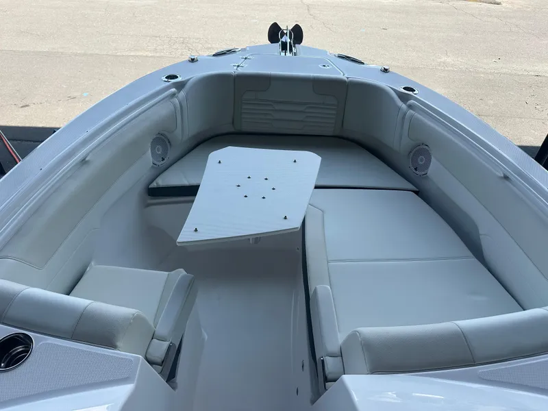 Slide: The Image of 2026 Edgewater 262CX Crossover boat interior with seating and table. - 31